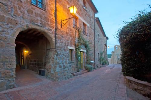 a stone building with a light on the side of a street at Hotel Scilla in Sovana