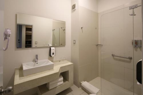 a bathroom with a sink and a shower at Casa Andina Standard Piura in Piura