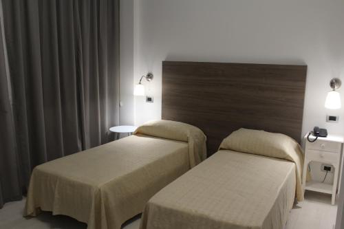 Säng eller sängar i ett rum på Hotel Miramare