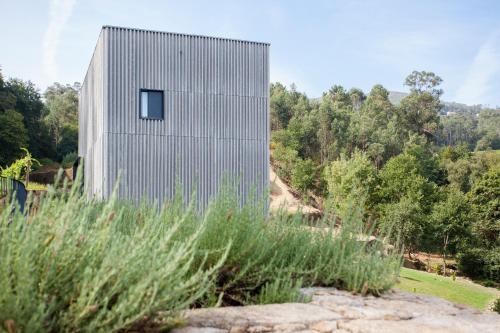 a concrete house with a small window on the side of it at Melgaço Alvarinho Houses in Melgaço