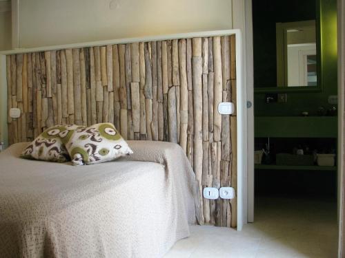 a bedroom with a bed with a wooden headboard at Maison RR in Saint-Tropez