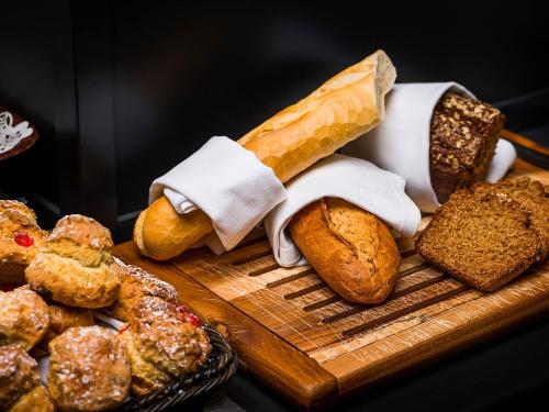 a bunch of bread and pastries on a cutting board at Kilmurry Lodge Hotel in Limerick