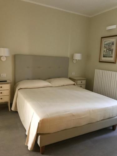 a bedroom with a large bed and two night stands at Agriturismo La Rinaldina in Faenza