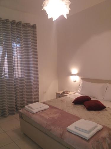 a bedroom with a bed with two towels on it at Depandance Machiavelli in Cagliari