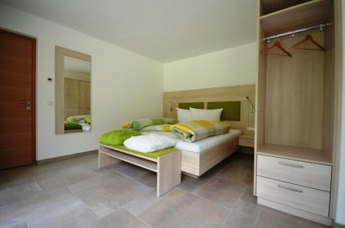 a bedroom with a bed and a large mirror at Panoramahof in Kastelbell-Tschars