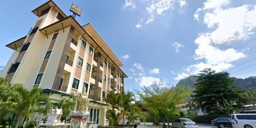 a building with a sign on the top of it at T.P. Place Hotel in Phangnga