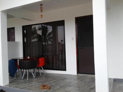 a room with a table and chairs and a door at Garden Village Resort in Moalboal