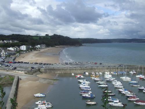 a bunch of boats in the water near a beach at Nythfa Guest House in Saundersfoot