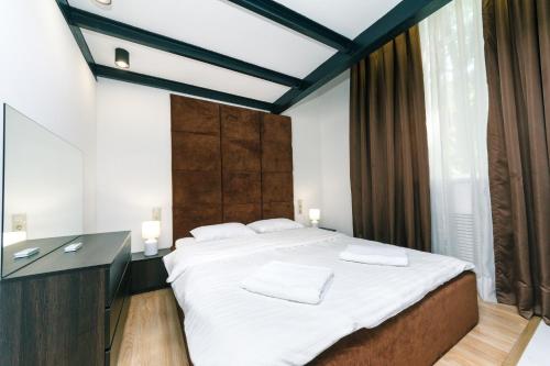 a bedroom with a large bed and a desk at VIP Apartment at Horodetskoho 4 in Kyiv