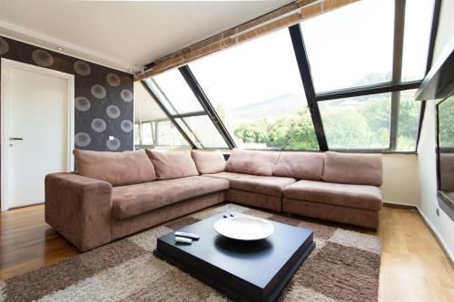 a living room with a couch and a table at Amazing Penthouse old town in Sarajevo