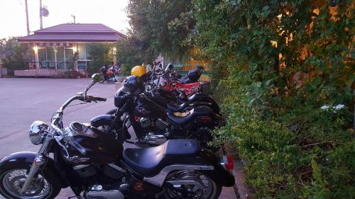 a row of motorcycles parked in a parking lot at Baan Sanpoom in Phitsanulok
