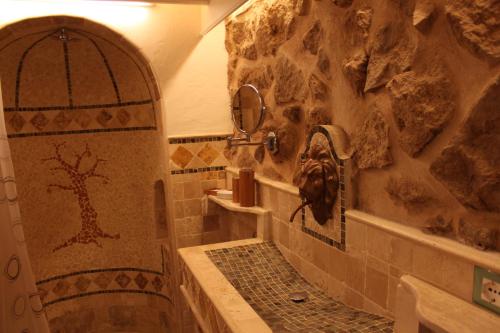 a bathroom with a shower with a stone wall at Citta Giardino B&B in Rome