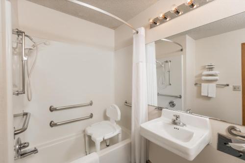 a bathroom with a sink and a toilet and a shower at Howard Johnson by Wyndham Wichita Airport in Wichita