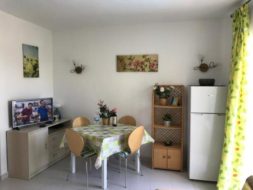 a dining room with a table and a refrigerator at Oasis Paradise in Denia