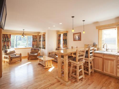 a kitchen with wooden floors and wooden cabinets at Nordic Lodge in Steamboat Springs