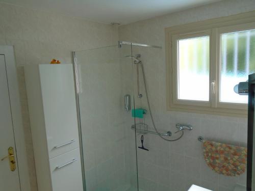 a bathroom with a shower with a glass door at Sans Souci in Cahuzac