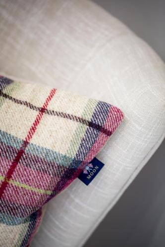 a close up of a plaid pillow on a plate at Darlington Arms in Redhill