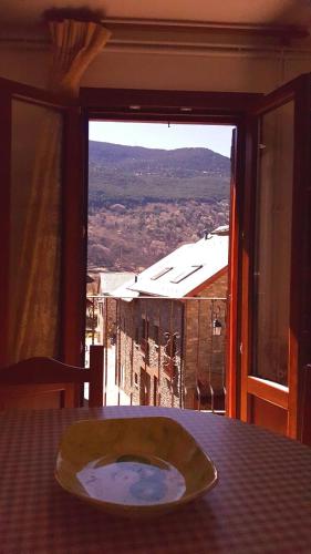 a table with a plate on a table with a view at Casa Joan in Barruera