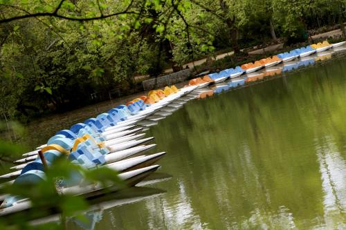 a group of boats lined up on the water at Hotel Termas da Curia in Curia