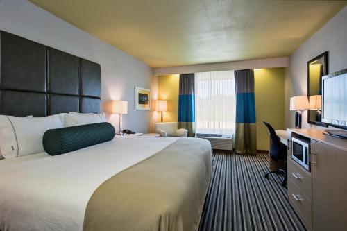 a hotel room with a large bed and a flat screen tv at Holiday Inn Express & Suites Carlisle, an IHG Hotel in Carlisle