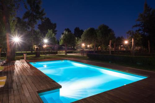 a swimming pool at night with lights at Quinta da Mimosa in Amieira