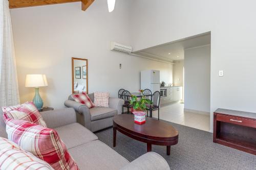 a living room with a couch and a table at Anzac Court Motel in Auckland