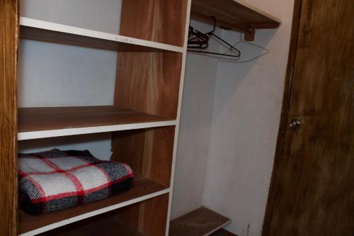 a book shelf with a red and white towel in it at Hotel Casa Tenango in Cobán