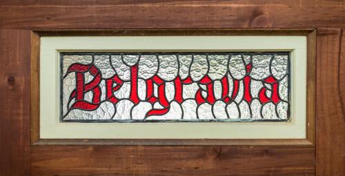 a stained glass window in a wooden wall at Belgravia Mountain Guest House in Katoomba