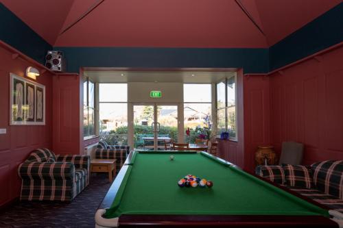 a pool table in a room with red walls at Belgravia Mountain Guest House in Katoomba