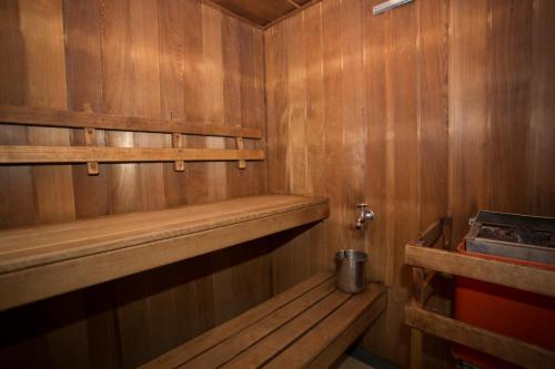 a wooden sauna with a bench and shelves in it at Belgravia Mountain Guest House in Katoomba