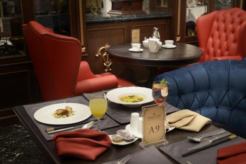 a table with plates of food and drinks on it at Golden Tulip RS Boutique Hotel-Tainan in Tainan