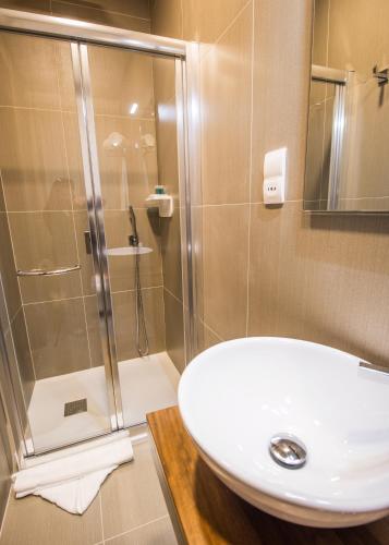 a bathroom with a white sink and a shower at BB De Rohan in Żebbuġ
