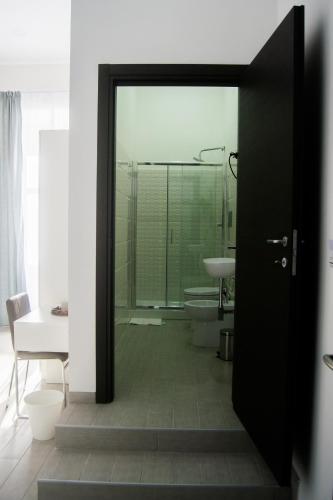 a bathroom with a shower and a toilet and a sink at Civico 7 in Naples