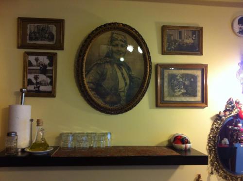 a mirror on a wall with glasses on a shelf at Guest House - Grandma's House in Istanbul