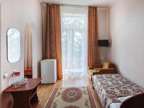 a hotel room with a bed and a window at Sanatoriy Pyatigorye in Pyatigorsk