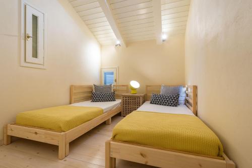 two twin beds in a room with at Villa Oliva, in a serene location & private pool, by ZanteWize in Akrotiri