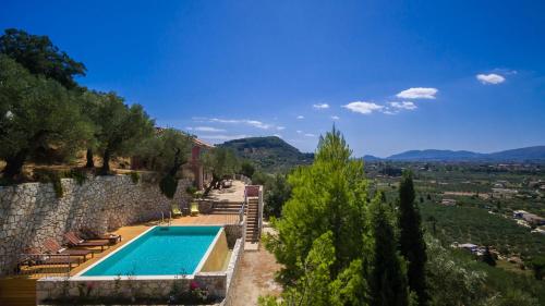 a swimming pool in a villa with a stone wall at Villa Oliva, in a serene location & private pool, by ZanteWize in Akrotiri