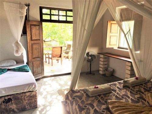 Ένα ή περισσότερα κρεβάτια σε δωμάτιο στο Miti Miwiri