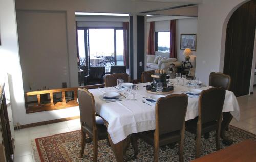 a dining room table with a white tablecloth and chairs at Villa Markos in Roitika