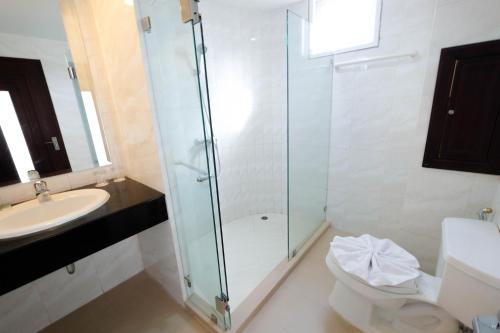 a bathroom with a shower and a toilet and a sink at LK Metropole (Junior Wing) in Pattaya Central
