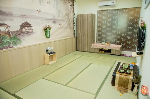 a room with a classroom with a chalkboard and a table at Ji Shih Life Style Hotel in Tainan