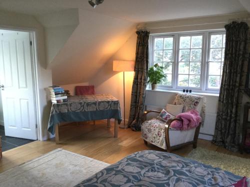a room with a bed and a table and a chair at Hurstbourne in Camberley