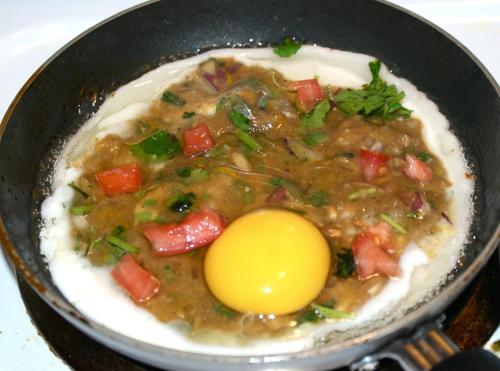 a pot of food with an egg on top at Tulaja Boutique Hotel in Bhaktapur