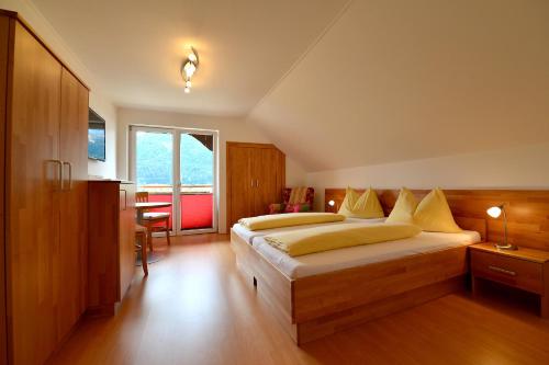 a large bedroom with two beds and a table at Haus Kalt in Weissensee