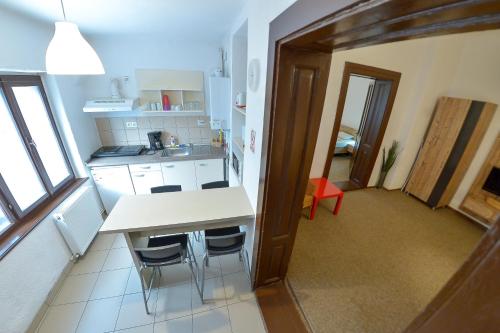 a kitchen with a counter and chairs in a room at Apartment Gabriel in Sibiu