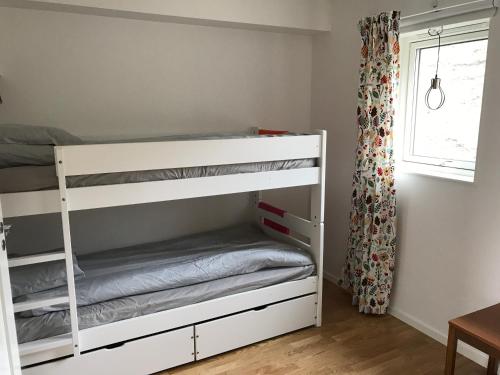 a white bunk bed in a room with a window at Vid Gondolen in Hemavan