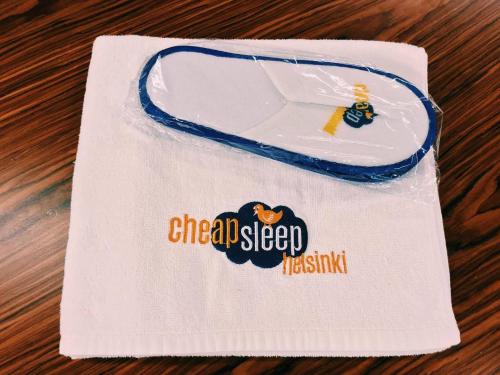 a white napkin with the words one all sleep on it at CheapSleep Hostel Helsinki in Helsinki