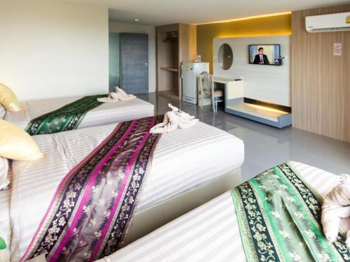 Llit o llits en una habitació de Silom Boutique Hotel Hatyai