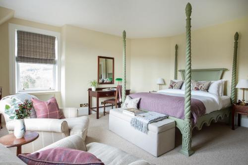 a bedroom with a bed and a living room at Craigellachie Hotel of Speyside in Craigellachie