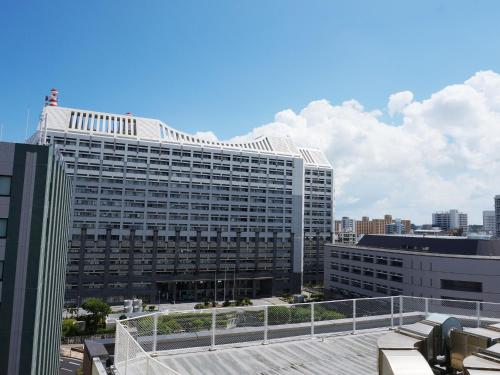 a large white building with a lot of windows at Hotel Abest Naha Kokusai Street in Naha